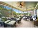 Enclosed porch with a ceiling fan and comfortable seating offering a serene outdoor experience at 5585 Lavender Farms, Powder Springs, GA 30127