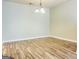 Inviting living room featuring stylish light fixture and sleek wood-look flooring at 8201 Fairington Village Dr, Lithonia, GA 30034
