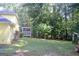 Expansive backyard showcasing a screened-in porch, lush lawn, and mature trees, perfect for outdoor relaxation and entertainment at 150 Ashley Dr, Fayetteville, GA 30214