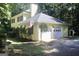 View of the rear and garage of the house featuring attached garage and private backyard at 150 Ashley Dr, Fayetteville, GA 30214
