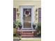 Charming home featuring a welcoming front door with a decorative wreath and colorful plants at 150 Ashley Dr, Fayetteville, GA 30214