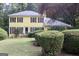 Charming two-story yellow home with red shutters and well-manicured front lawn at 150 Ashley Dr, Fayetteville, GA 30214