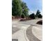 Stone trimmed flower beds with red and pink flowers lining cobblestone road at 150 Ashley Dr, Fayetteville, GA 30214