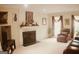 Inviting living room with a fireplace, neutral carpet and comfortable seating area at 150 Ashley Dr, Fayetteville, GA 30214
