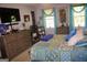 Comfortable bedroom featuring a large bed, dresser, and window for natural light at 150 Ashley Dr, Fayetteville, GA 30214