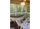 Relaxing screened porch with a hammock, perfect for enjoying the outdoors with a table and chairs at 150 Ashley Dr, Fayetteville, GA 30214