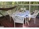 Cozy screened porch with outdoor seating around a decorated table, creating an ideal setting for relaxation at 150 Ashley Dr, Fayetteville, GA 30214