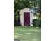 Outdoor shed with a dark red door and a yellow exterior, adding functional storage space to the property at 150 Ashley Dr, Fayetteville, GA 30214
