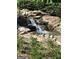 Cascading water feature amidst natural rocks and green foliage at 150 Ashley Dr, Fayetteville, GA 30214