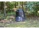 Backyard featuring a compost bin surrounded by trees and foliage, an eco-friendly addition for gardening enthusiasts at 150 Ashley Dr, Fayetteville, GA 30214
