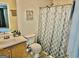 Well-lit bathroom with a large patterned shower curtain at 3219 Fairington Dr, Lithonia, GA 30038