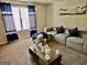 Inviting living room features neutral tones, plush seating, and bright natural light from a large window at 3219 Fairington Dr, Lithonia, GA 30038