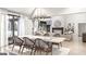 Open-concept dining room flows into the living room and features a modern chandelier, hardwood floors, and stone fireplace at Lot 1 Bohannon Drive # 1, Fairburn, GA 30213
