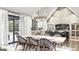 Bright open-concept dining room leading to the kitchen features a modern chandelier and view of the backyard at Lot 1 Bohannon Drive # 1, Fairburn, GA 30213