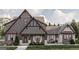 Beautiful exterior elevation with a blend of stone and siding and a covered front porch with seating area at Lot 1 Bohannon Drive # 1, Fairburn, GA 30213
