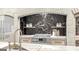 A gold faucet sits above a marble kitchen island, and the black marble backsplash is visible behind the gas cooktop at Lot 1 Bohannon Drive # 1, Fairburn, GA 30213