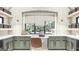 Well-lit butler's pantry features sage green cabinets, open shelving, and large windows with a view of the outdoors at Lot 1 Bohannon Drive # 1, Fairburn, GA 30213