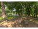 Peaceful backyard with mature trees, a tranquil lake view, and comfortable seating area at 1051 Lake Rutledge Rd, Rutledge, GA 30663