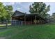 Open air barn with metal roof and fenced pen perfect for livestock at 1051 Lake Rutledge Rd, Rutledge, GA 30663