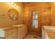 Bathroom boasts double sinks, wood wall paneling, and great natural lighting at 1051 Lake Rutledge Rd, Rutledge, GA 30663