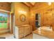Well lit bathroom features double sinks, and wood wall paneling at 1051 Lake Rutledge Rd, Rutledge, GA 30663