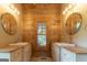 Bathroom features double sinks, wood paneling, and a center window at 1051 Lake Rutledge Rd, Rutledge, GA 30663