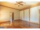 Well-lit bedroom featuring hardwood floors, a ceiling fan, and access to an ensuite bathroom at 1051 Lake Rutledge Rd, Rutledge, GA 30663