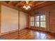 Spacious, wood-paneled bedroom with a ceiling fan and large window that offers an abundance of natural light at 1051 Lake Rutledge Rd, Rutledge, GA 30663