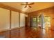 Spacious bedroom with hardwood floors, a ceiling fan, french doors, and lots of natural light at 1051 Lake Rutledge Rd, Rutledge, GA 30663