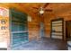 Spacious bonus room featuring wood paneled walls, ceiling fan, and painted built in shelving units at 1051 Lake Rutledge Rd, Rutledge, GA 30663