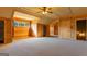 Expansive bonus room boasts natural wood walls, ceiling fan, and access to additional rooms at 1051 Lake Rutledge Rd, Rutledge, GA 30663