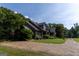Charming home with a mature landscape, stone accents, and a long driveway at 1051 Lake Rutledge Rd, Rutledge, GA 30663