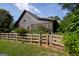 Home exterior with a beautiful wood fence and lush green lawn at 1051 Lake Rutledge Rd, Rutledge, GA 30663
