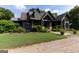 Charming home featuring a landscaped front yard, stone accents, and a welcoming covered entry at 1051 Lake Rutledge Rd, Rutledge, GA 30663