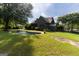Exterior view showcasing a well-maintained home, a beautiful pool, and a lush green lawn at 1051 Lake Rutledge Rd, Rutledge, GA 30663