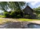 Charming home exterior featuring a stone walkway, well-manicured lawn, and lush landscaping at 1051 Lake Rutledge Rd, Rutledge, GA 30663
