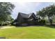 Picturesque home with mature lawn, matching shed, and privacy fence at 1051 Lake Rutledge Rd, Rutledge, GA 30663