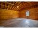 Spacious two car garage interior with wood paneling, concrete floor and a window at 1051 Lake Rutledge Rd, Rutledge, GA 30663