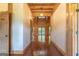 Warm hallway with wood ceiling and flooring leading to an open living space with abundant natural light at 1051 Lake Rutledge Rd, Rutledge, GA 30663
