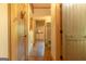 Hallway with wooden doors, stone floors, and views into attached rooms and bathrooms at 1051 Lake Rutledge Rd, Rutledge, GA 30663