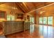 Well-lit kitchen boasting an island with seating, wood cabinets, and abundant natural light from large windows at 1051 Lake Rutledge Rd, Rutledge, GA 30663