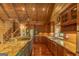 Gourmet kitchen with granite countertops, stainless steel appliances, custom wood cabinets, and a view to the staircase at 1051 Lake Rutledge Rd, Rutledge, GA 30663