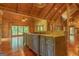 Gourmet kitchen with a central island, modern appliances, and an open layout with seamless flow to living areas at 1051 Lake Rutledge Rd, Rutledge, GA 30663
