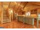 Open kitchen featuring a center island, stainless steel appliances, and staircase leading to the second floor at 1051 Lake Rutledge Rd, Rutledge, GA 30663