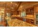 Well-equipped kitchen with stainless steel appliances, a granite countertop island, and beautiful custom wood cabinets at 1051 Lake Rutledge Rd, Rutledge, GA 30663