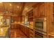 Gourmet kitchen featuring granite countertops, custom wood cabinets, stainless steel appliances, and recessed lighting at 1051 Lake Rutledge Rd, Rutledge, GA 30663