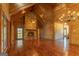 Bright living room with a stone fireplace, cathedral ceilings, and French doors leading to the outside at 1051 Lake Rutledge Rd, Rutledge, GA 30663
