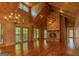 Spacious living room featuring a stone fireplace, wood-paneled walls, and cathedral ceilings at 1051 Lake Rutledge Rd, Rutledge, GA 30663