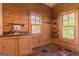 A wood-paneled mud room with sink, storage, and two windows at 1051 Lake Rutledge Rd, Rutledge, GA 30663
