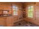 A well-lit, wood-paneled mud room featuring a sink, storage, and window at 1051 Lake Rutledge Rd, Rutledge, GA 30663